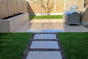 Completed in just 5 days from project Porcelain Paving, Raised Flower bed, Artificial grass